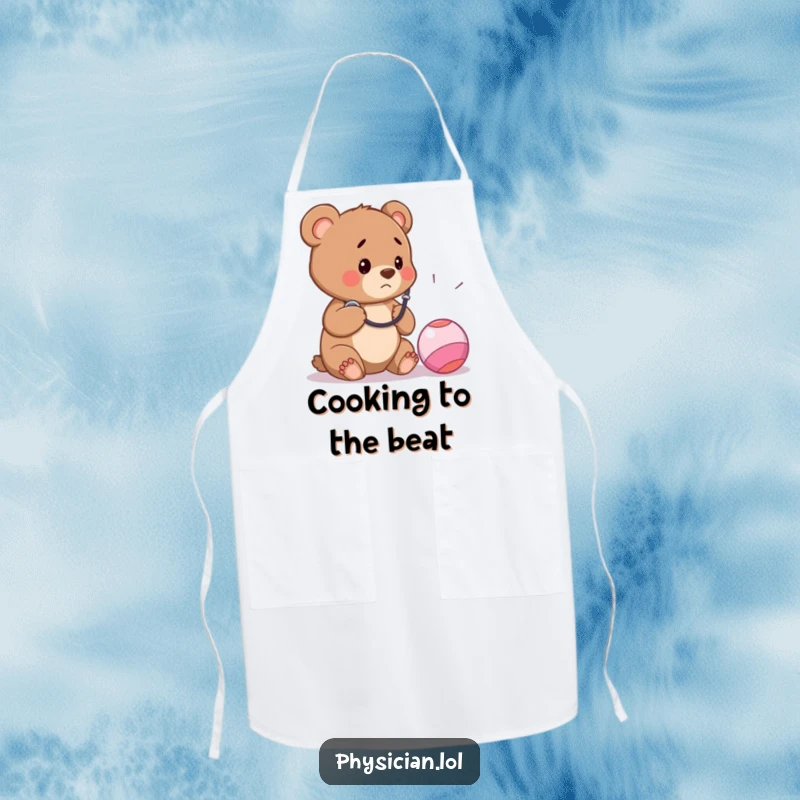 Funny apron featuring a concerned bear cub doctor using a stethoscope on a bouncy ball, ideal for kitchen humor and playful chefs.
