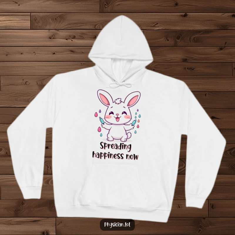 Funny hoodie depicting a cheerful bunny character happily giving colorful drops, symbolizing joy and gentle healing.